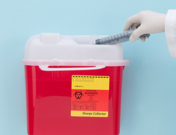 Red sharps disposal container