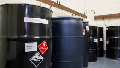 Black barrels marked with flammable liquid red sticker